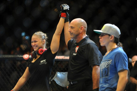Jul 5, 2014; Las Vegas, NV, USA; Ronda Rousey (red gloves) celebrates her victory over Alexis Davis during the first round of their bantamweight fight at Mandalay Bay Events Center.
