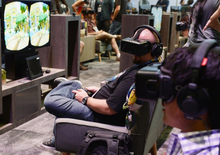 An attendee tries on the Oculus VR Inc. Rift Development Kit 2 headset at the 2014 Electronic Entertainment Expo (E3) in Los Angeles, California June 11, 2014.