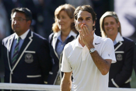 Roger Federer of Switzerland blows kisses.