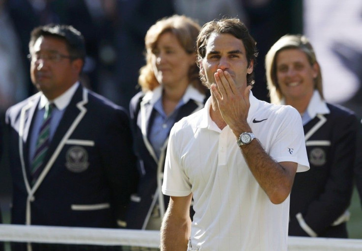 Roger Federer of Switzerland blows kisses.