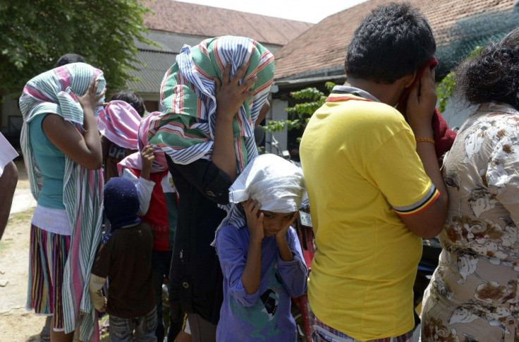 Sri Lankan asylum seekers who were sent back by Australia wait to enter a magistrate's court in Galle