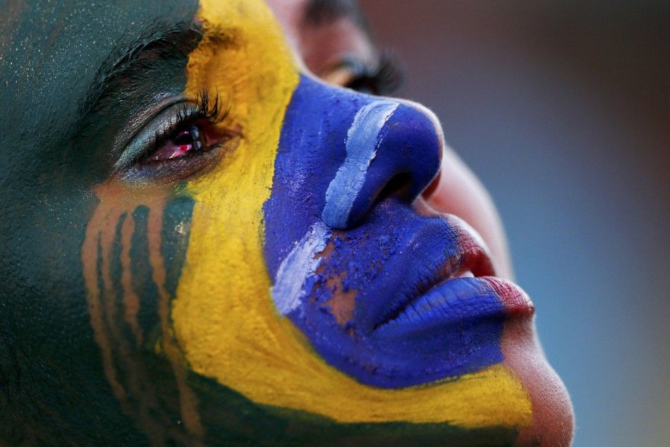 A Brazil fan cries as she watches the 2014 World Cup semi-final between Brazil and Germany at a fan area in Brasilia