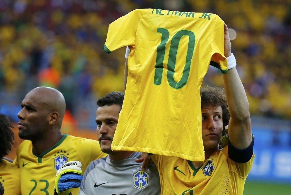 Brazils David Luiz holds up the jersey of his teammate Neymar before their 2014 World Cup semi-finals against Germany in Belo Horizonte