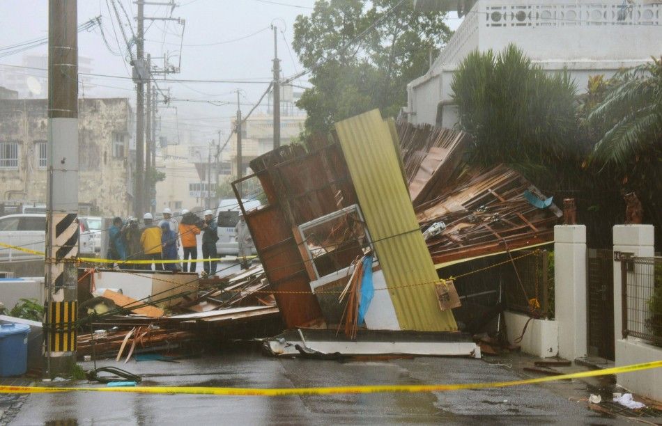 A wooden house which collapsed due to strong winds caused by Typhoon Neoguri is seen in Naha, on Japans southern island of Okinawa, in this photo taken by Kyodo July 8, 2014. One man died, more than 500,000 people were urged to evacuate and hundreds of f