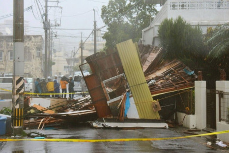 A wooden house which collapsed due to strong winds caused by Typhoon Neoguri is seen in Naha, on Japan's southern island of Okinawa, in this photo taken by Kyodo July 8, 2014. One man died, more than 500,000 people were urged to evacuate and hundreds of f