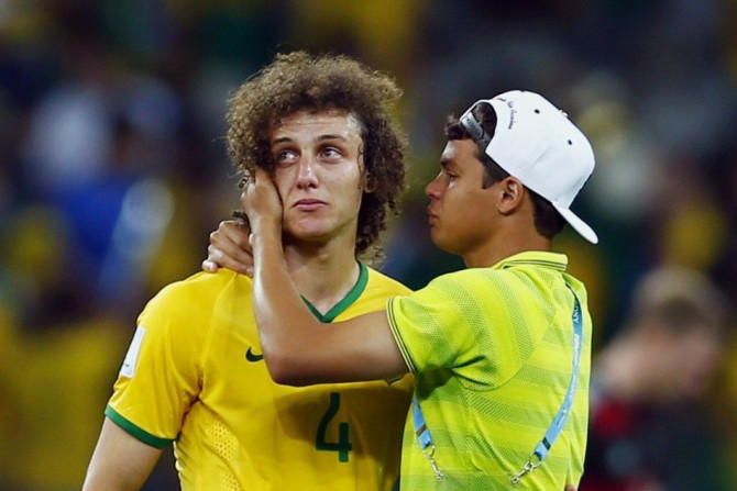 Brazil&#039;s David Luiz (L) is consoled by teammate Thiago Silva