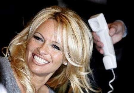 Actress Pamela Anderson Smiles as She Talks on the Phone with Frances Actress Brigitte Bardot Not Pictured During a Visit to Bardots Foundation for Animals Rights in Paris
