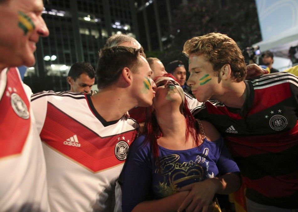 Germany soccer fans kiss a Brazilian fan