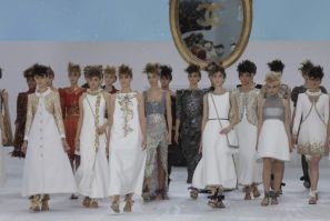 Models present creations by German designer Karl Lagerfeld at the end of his Haute Couture Fall/Winter 2014-2015 fashion show for French fashion house Chanel in Paris