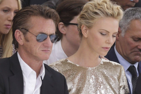 Actors Sean Penn and Charlize Theron attend the French fashion house Christian Dior Haute Couture Fall/Winter 2014-2015 fashion show by Belgian designer Raf Simons in Paris