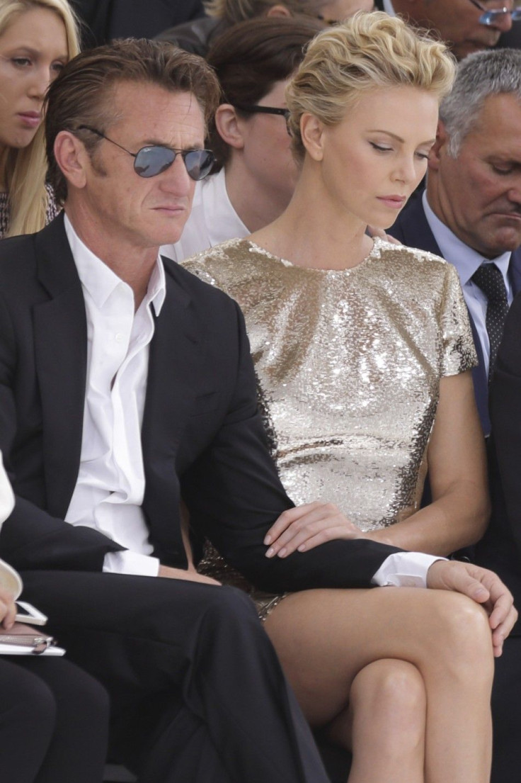 Actors Sean Penn and Charlize Theron attend the French fashion house Christian Dior Haute Couture Fall/Winter 2014-2015 fashion show by Belgian designer Raf Simons in Paris
