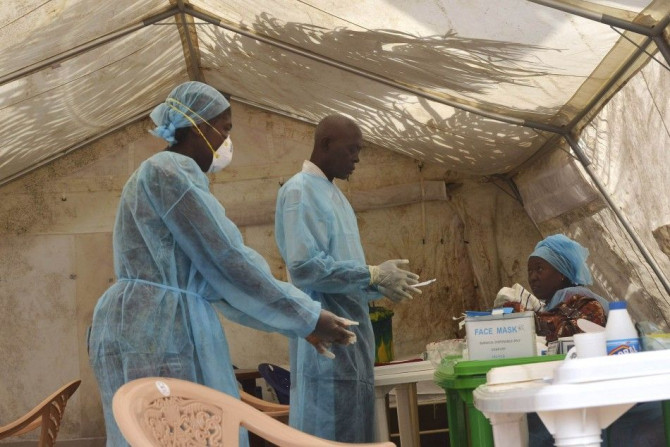 Health workers take blood samples for Ebola virus testing at a screening tent in the local government hospital in Kenema