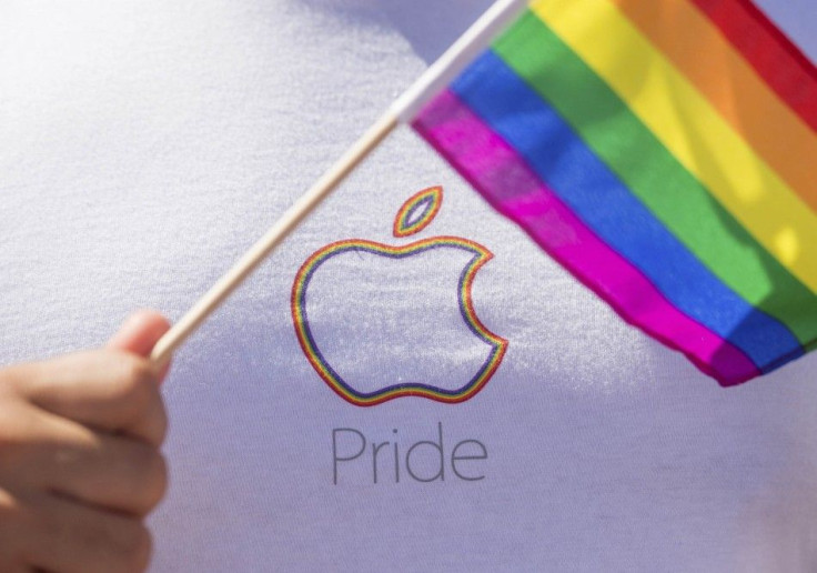 An Apple Employee Waves A Rainbow Flag Before Marching In The San Francisco.