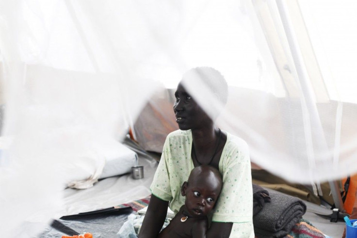 Woman suffering from Tuberculosis holds her baby, who suffers from TB and malnutrition, in a hospital in Minakaman