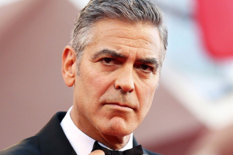 U.S. actor George Clooney adjusts his bowtie as he arrives for the premiere of &quot;Gravity&quot; at the 70th Venice Film Festival in Venice in this file photo taken August 28, 2013.