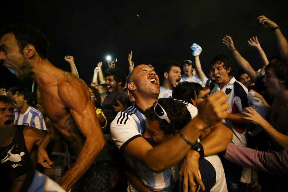 Argentina fans react after their team won the 2014 World Cup semi-final match against the Netherlands as they watched at Copacabana beach in Rio de Janeiro