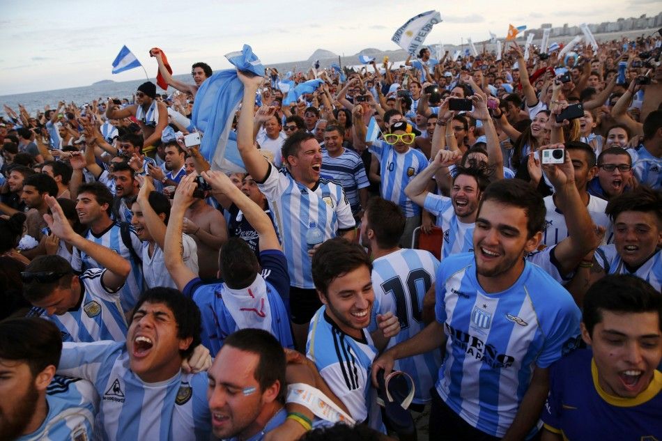 Argentina soccer fans react as they watch a broadcast of the 2014 World Cup semi-final between Argentina and the Netherlands at Copacabana beach in Rio de Janeiro