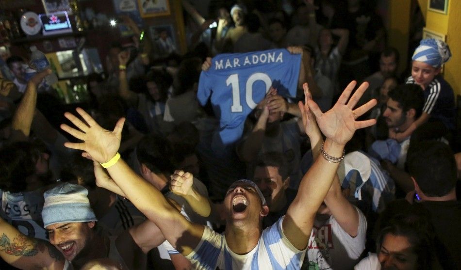 Argentina fans celebrate their teams victory at the end of the 2014 World Cup semi-final soccer match against the Netherlands at the Mooca neighborhood bar in Sao Paulo