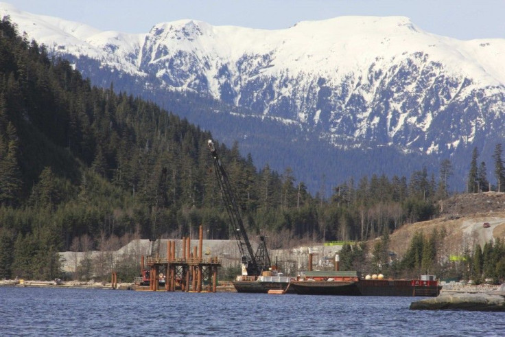Cranes work in the water at the Kitimat LNG site near Kitimat, in northwestern British Columbia on April 13, 2014. British Columbia is on the brink of an energy boom. Domestic and foreign companies are looking to build two oil pipelines, multiple natural 