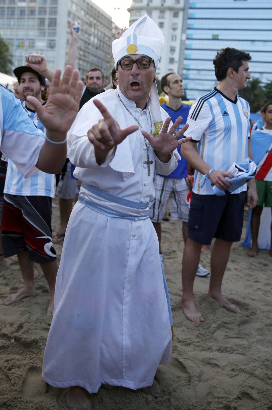 An Argentinian soccer fan dressed up as Pope Francis dances before a broadcast of the 2014 World Cup semi-final between Argentina and the Netherlands at Copacabana beach in Rio de Janeiro, July 9, 2014.   REUTERSPilar Olivares BRAZIL  - Tags SOCCER SPO
