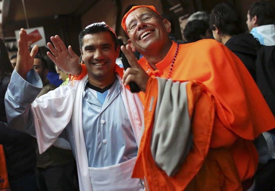 Fans of Argentina and the Netherlands dressed up as Pope Francis wait for a train at the Luz Station to catch the 2014 World Cup semi-final soccer match between Argentina and Netherlands at Corinthians arena in Sao Paulo July 9, 2014.   REUTERSNacho Doce