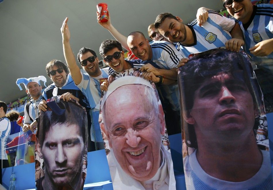 Argentina fans hold pictures of L-R Argentinas Lionel Messi, Pope Francis and Diego Maradona before the 2014 World Cup round of 16 game between Argentina and Switzerland at the Corinthians arena in Sao Paulo July 1, 2014. REUTERSKai Pfaffenbach BRAZI