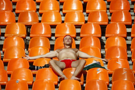 A spectator tans himself in the sun during the IAAF World Athletics Championships in Moscow