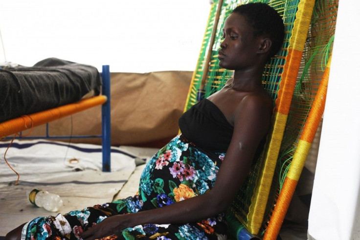 Pregnant woman sits on the floor at a hospital in Minakaman