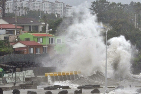 Waves crash as Typhoon Neoguri approaches the village in Seogwipo on Jeju Island July 9, 2014. Jeju Regional Meteorological Administration renewed its alert level from typhoon watches to typhoon warnings for east and west coast of Jeju Island on Wednesday