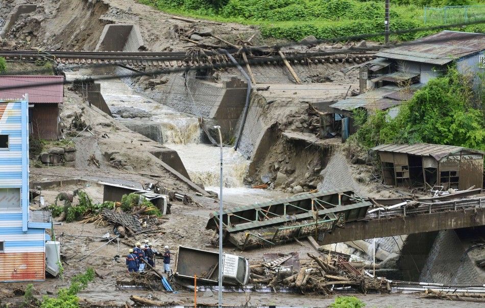Damaged cars and buildings are seen after a landslide caused by heavy rains due to Typhoon Neoguri in Nagiso town, Nagano prefecture, in this photo taken by Kyodo July 10, 2014. A landslide pummelled the town of Nagiso in central Japan late on Wednesday, 