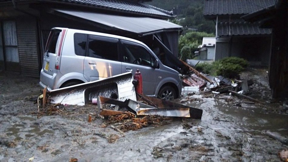 Cars and buildings damaged by a landslide caused by heavy rains set off by Typhoon Neoguri are seen in Nagiso town, Nagano Prefecture, in this photo taken by Nagano Prefecture July 9, 2014. Heavy rain battered a wide swathe of Japan on Thursday, sending r