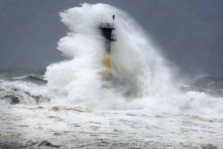 Waves brought about by Typhoon Neoguri hits a lighthouse in Seogwipo on Jeju Island July 9, 2014. Jeju Regional Meteorological Administration renewed its alert level from typhoon watches to typhoon warnings for east and west coast of Jeju Island on Wednes
