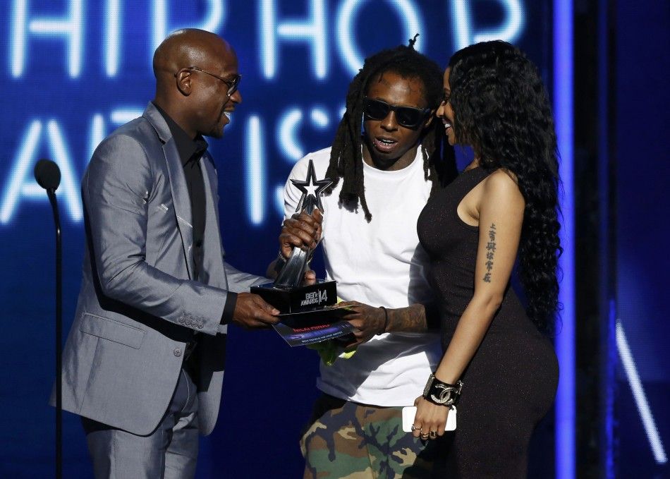 Floyd Mayweather Jr L presents best female hip hop artist to Nicki Minaj R as Lil Wayne joins her onstage during the 2014 BET Awards in Los Angeles, California June 29, 2014.