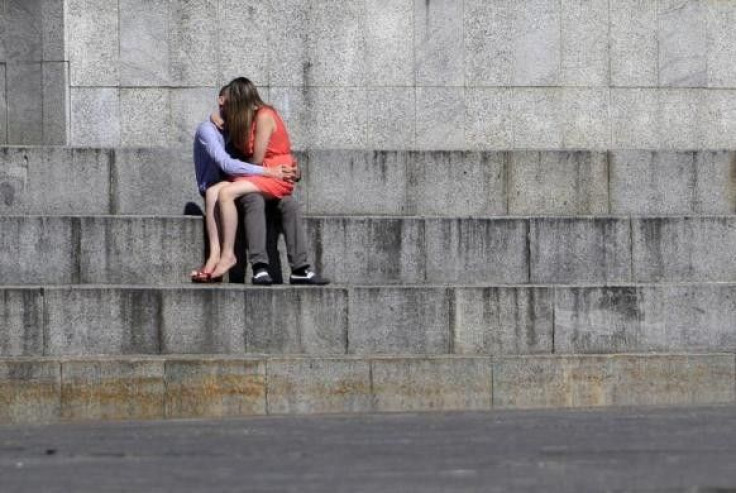 A couple share a kiss in Independence Square in central Kiev, July 24, 2012.