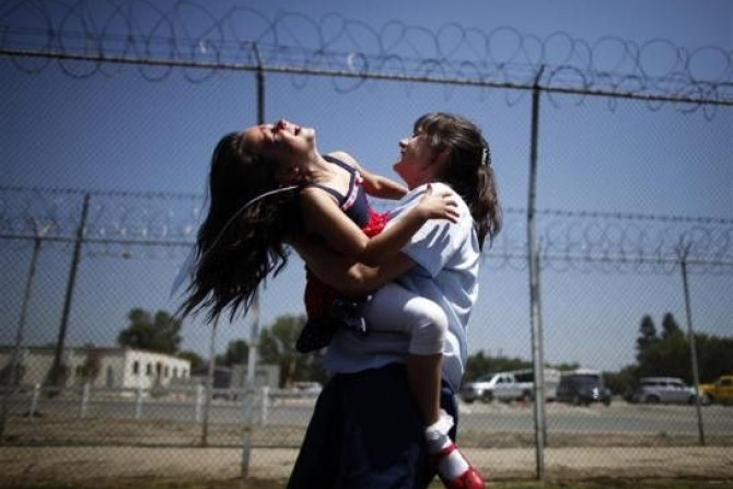Cori Walters, 32, (R) hugs her daughter Hannah Walters, 6, at California Institute for Women state prison in Chino, California May 5, 2012.