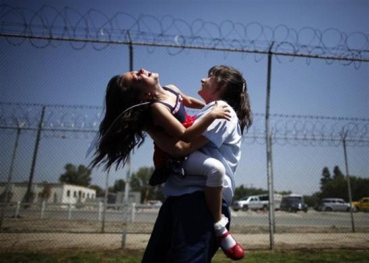 Cori Walters, 32, (R) hugs her daughter Hannah Walters, 6, at California Institute for Women state prison in Chino, California May 5, 2012.