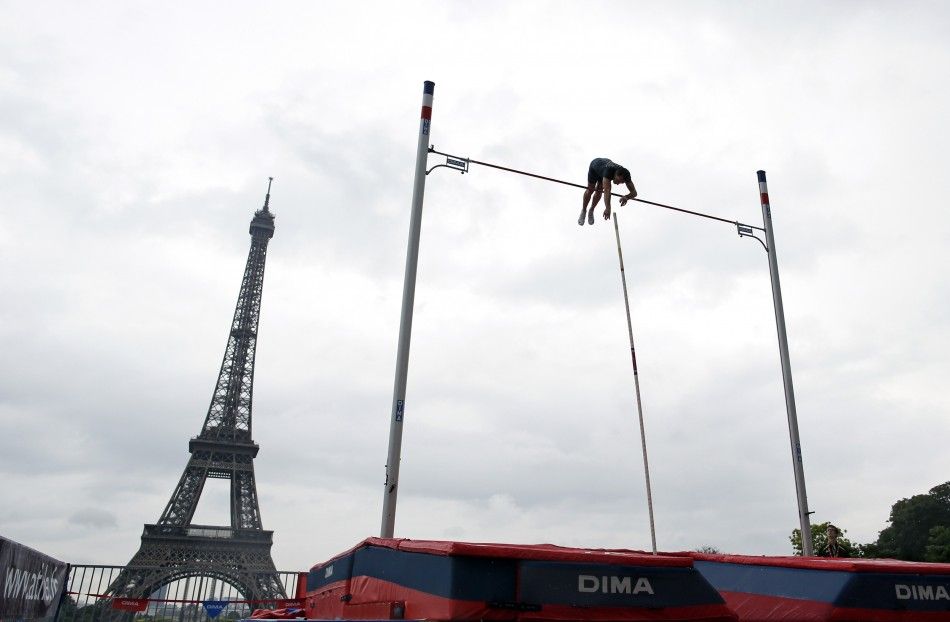 Olympic pole vault champion Renaud Lavillenie of France takes part in a mens exhibition pole vaulting competition with the Eiffel Tower in the background in Paris June 28, 2014. REUTERSBenoit Tessier FRANCE - Tags SPORT ATHLETICS