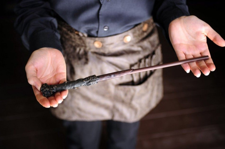 A team member shows off an interactive magic wand during a media preview for The Wizarding World of Harry Potter-Diagon Alley at the Universal Orlando Resort in Orlando, Florida