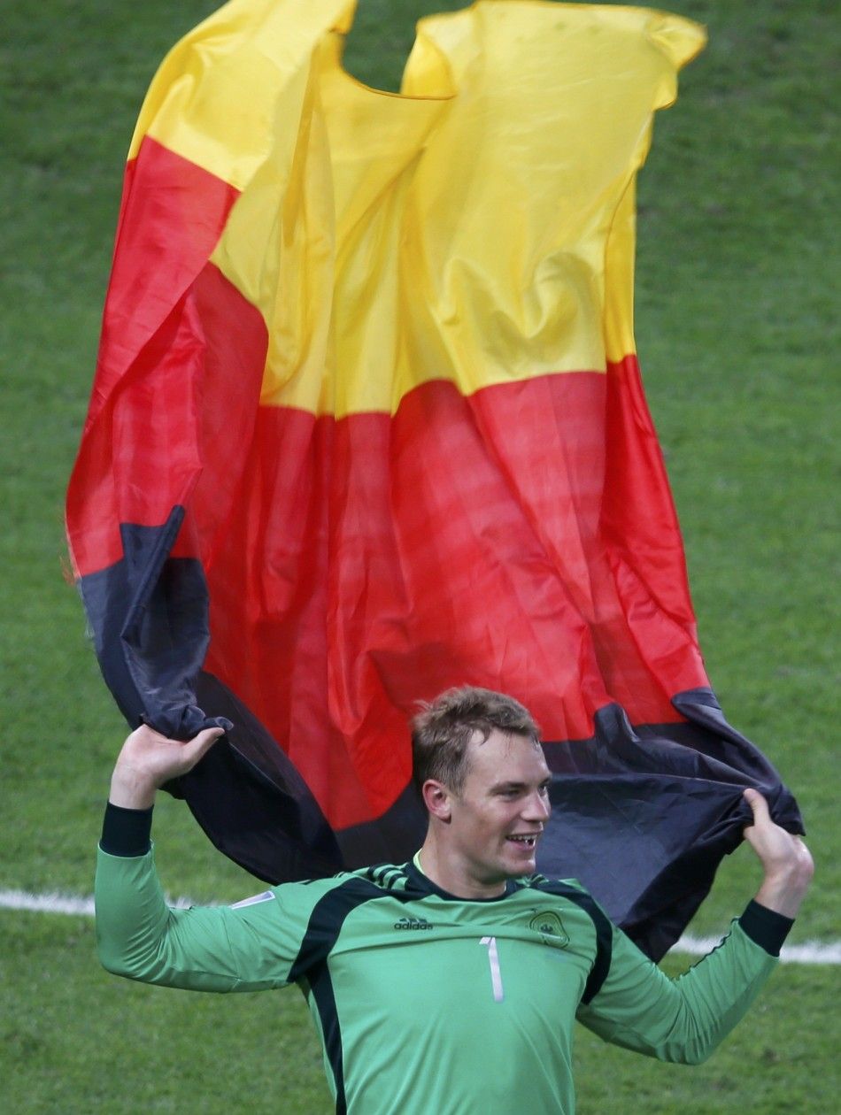 Germanys goalkeeper Neuer celebrates holding a national flag after winning the 2014 World Cup final against Argentina at the Maracana stadium in Rio de Janeiro