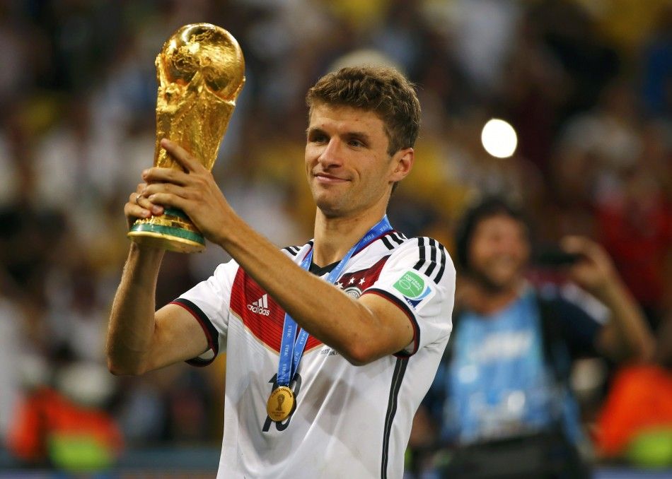 Germanys Thomas Mueller holds up the trophy after winning the 2014 World Cup final between Germany and Argentina at the Maracana stadium