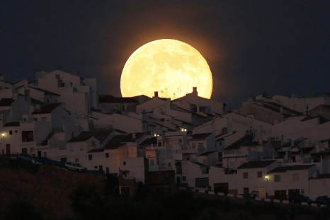 The Supermoon rises over houses in Olvera, in the southern Spanish province of Cadiz, July 12, 2014. Occurring when a full moon or new moon coincides with the closest approach the moon makes to the Earth, the Supermoon results in a larger-than-usual appea