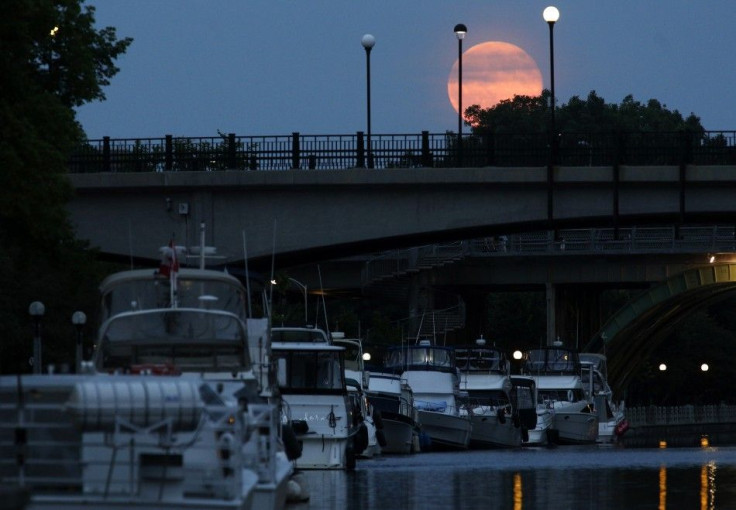 A Supermoon is seen over the Rideau Canal in Ottawa July 12, 2014. Occurring when a full moon or new moon coincides with the closest approach the moon makes to the Earth, the Supermoon results in a larger-than-usual appearance of the lunar disk. 