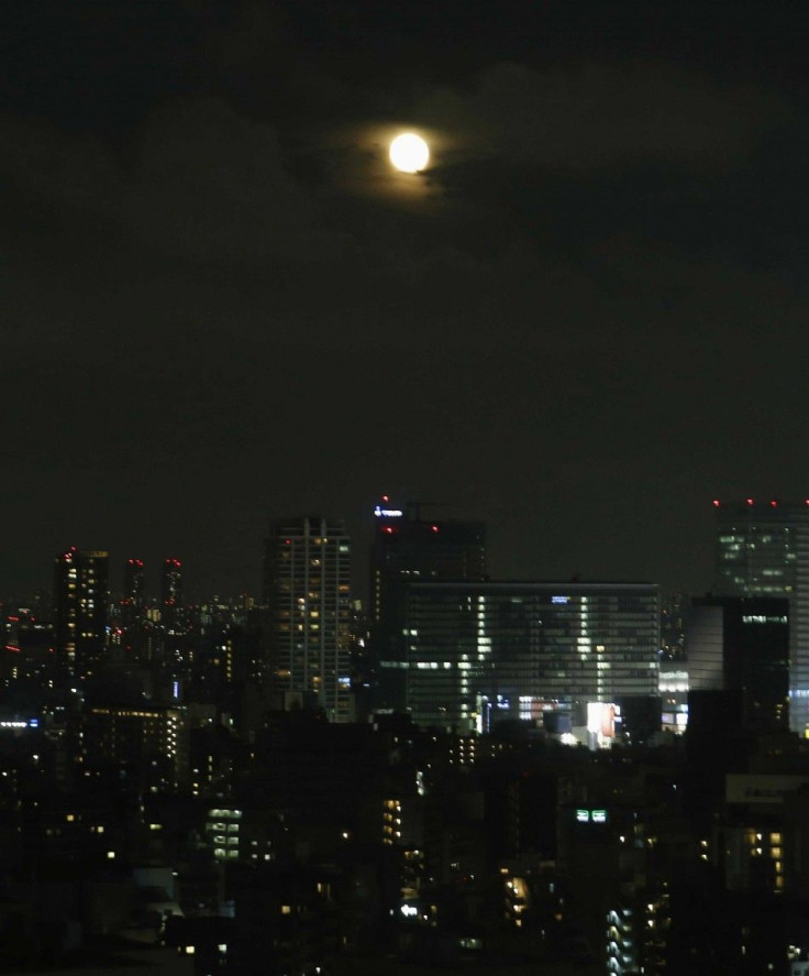 A full moon, known as a &quot;supermoon&quot;, rises over downtown Tokyo July 13, 2014. The astronomical event occurs when the moon is closest to the Earth in its orbit, making it appear much larger and brighter than usual. 