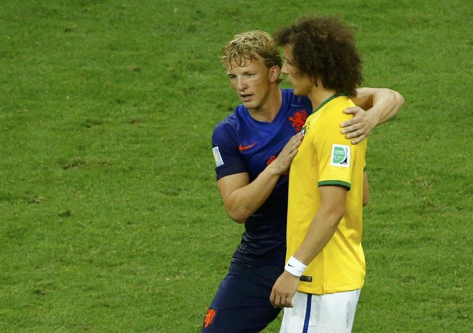 Dirk Kuyt of the Netherlands consoles Brazils David Luiz 