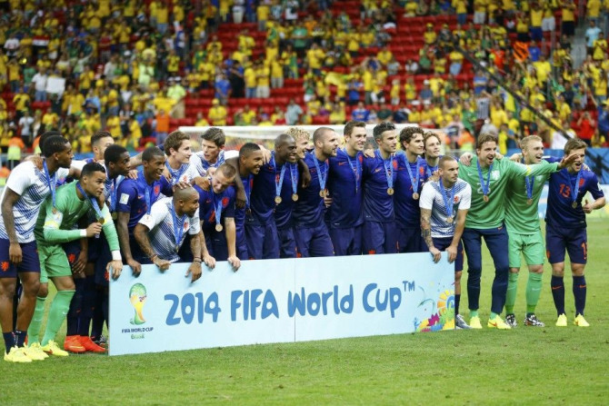 The Netherlands team poses for pictures after winning their 2014 World Cup third-place playoff
