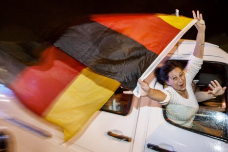 German fans celebrate as they drive along the 'Reeperbahn' red light district in Hamburg after Germany won the World Cup soccer final against Argentina, July 13, 2014. REUTERS/Morris Mac Matzen (GERMANY - Tags: SOCIETY SPORT SOCCER WORLD CUP TPX IMAGES OF