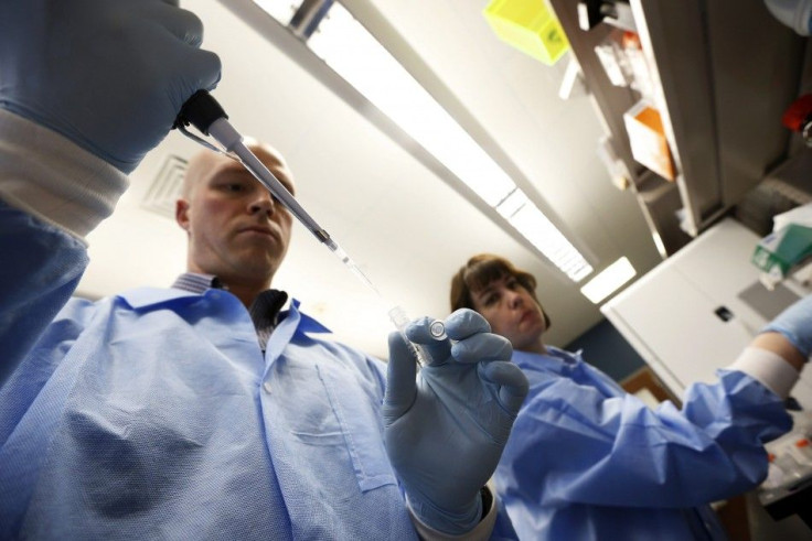 Molecular Genetics Technical Specialist Jaime Wendt (R) and Mike Tschannen work in the Human and Molecular Genetics Center Sequencing Core at the Medical College of Wisconsin in Milwaukee May 9, 2014.