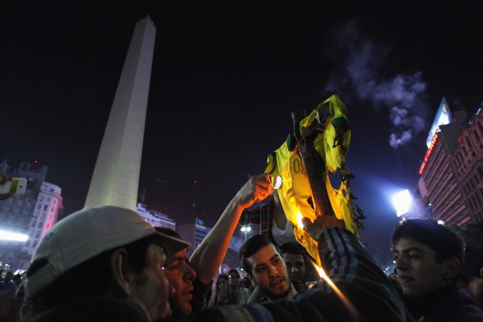 Argentinas fans set fire to a Brazil soccer jersey as they gather around the Obelisk after Argentina lost to Germany in their 2014 World Cup final soccer match in Brazil, at a public square viewing area in Buenos Aires, July 13, 2014. REUTERSMartin Acos