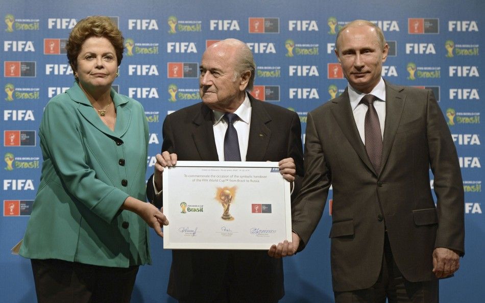 Russias President Vladimir Putin R, Brazils President Dilma Rousseff L and FIFA President Sepp Blatter take part in the official hand over ceremony for the 2018 World Cup scheduled to take place in Russia, in Rio de Janeiro July 13, 2014. 