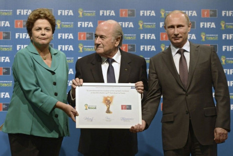 Russia's President Vladimir Putin (R), Brazil's President Dilma Rousseff (L) and FIFA President Sepp Blatter take part in the official hand over ceremony for the 2018 World Cup scheduled to take place in Russia, in Rio de Janeiro July 13, 2014. 